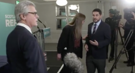 A Reform staffer manhandles a journalist during interview with Malcolm Offord