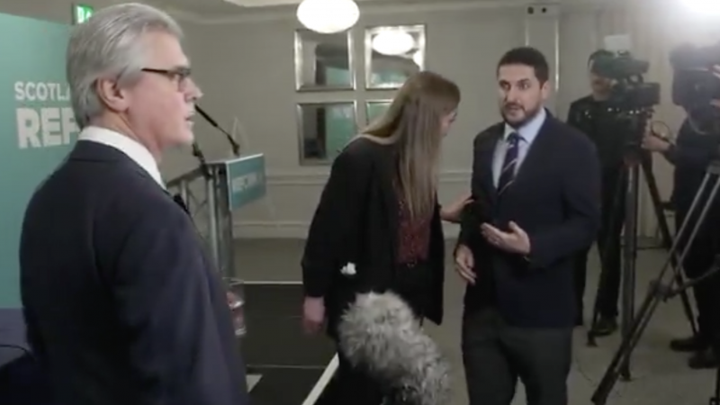 A Reform staffer manhandles a journalist during interview with Malcolm Offord