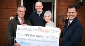 Nigel Farage posing with the winners of his energy bill giveaway